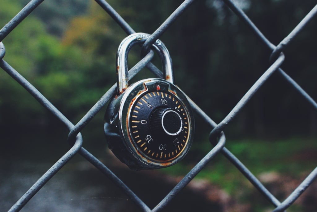 Combination lock on chain link fence